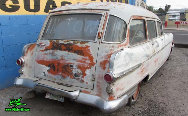 Photo of a faded grey 1956 Pontiac Memphian Ambulance in Phoenix, Arizona. Once painted red & white, in service for the Sheridan Willamina Fire Department in Oregon, build by the Memphian Coach Company in Memphis, Tennessee. Tail lights of a 1956 Pontiac Memphian Ambulance
