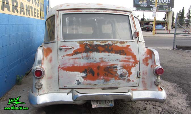 Photo of a faded grey 1956 Pontiac Memphian Ambulance in Phoenix, Arizona. Once painted red & white, in service for the Sheridan Willamina Fire Department in Oregon, build by the Memphian Coach Company in Memphis, Tennessee. Rear view of a 1956 Pontiac Memphian Ambulance
