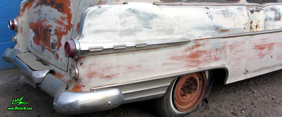 Photo of a faded grey 1956 Pontiac Memphian Ambulance in Phoenix, Arizona. Once painted red & white, in service for the Sheridan Willamina Fire Department in Oregon, build by the Memphian Coach Company in Memphis, Tennessee. Tail light & fin of a 1956 Pontiac Memphian Ambulance