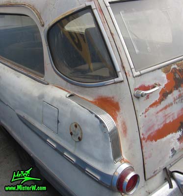 Photo of a faded grey 1956 Pontiac Memphian Ambulance in Phoenix, Arizona. Once painted red & white, in service for the Sheridan Willamina Fire Department in Oregon, build by the Memphian Coach Company in Memphis, Tennessee. Tail fin & back windows of a 1956 Pontiac Memphian Ambulance