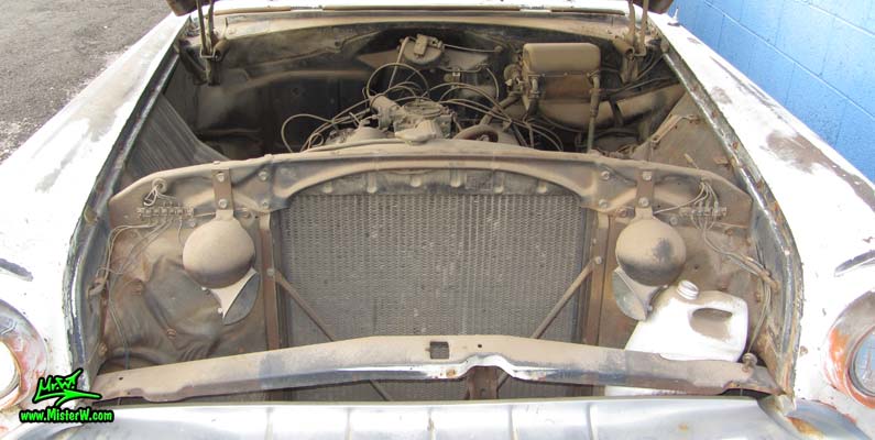 Photo of a faded grey 1956 Pontiac Memphian Ambulance in Phoenix, Arizona. Once painted red & white, in service for the Sheridan Willamina Fire Department in Oregon, build by the Memphian Coach Company in Memphis, Tennessee. Under the hood of a 1956 Pontiac Memphian Ambulance