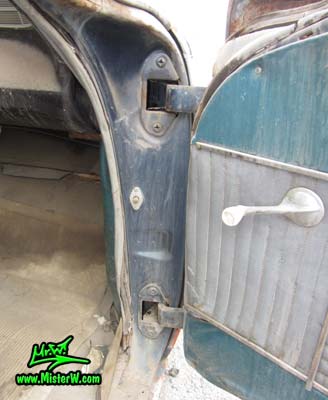 Photo of a faded grey 1956 Pontiac Memphian Ambulance in Phoenix, Arizona. Once painted red & white, in service for the Sheridan Willamina Fire Department in Oregon, build by the Memphian Coach Company in Memphis, Tennessee. Passenger door hinges of a 1956 Pontiac Memphian Ambulance