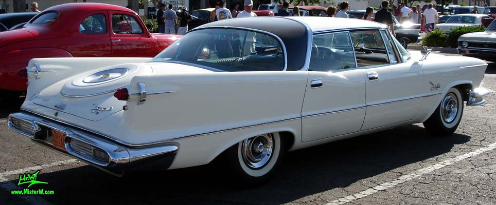 Photo of a white 1957 Imperial 4 Door Hardtop Sedan at the Scottsdale Pavilions Classic Car Show in Arizona. Tail fins of a 1957 Imperial