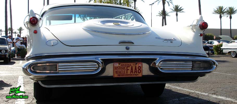Photo of a white 1957 Imperial 4 Door Hardtop Sedan at the Scottsdale Pavilions Classic Car Show in Arizona. Rearview of a 1957 Imperial