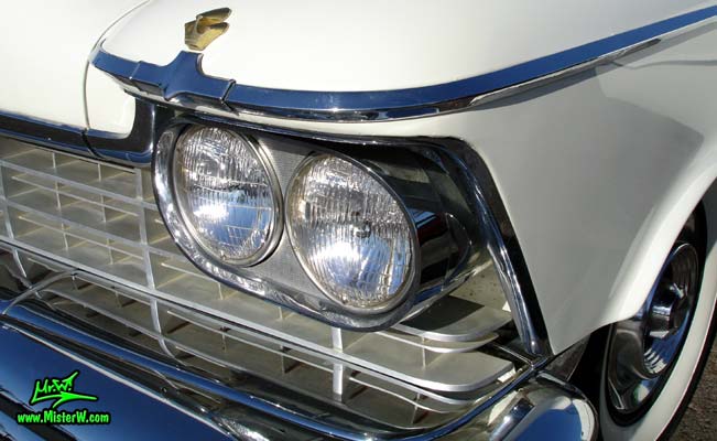 Photo of a white 1957 Imperial 4 Door Hardtop Sedan at the Scottsdale Pavilions Classic Car Show in Arizona. 1957 Imperial Head Light