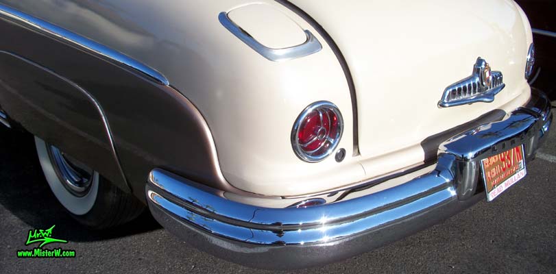 Photo of a tan 1949 Lincoln 9EL Series 4 door Sport Sedan with suicide doors at the Scottsdale Pavilions Classic Car Show in Arizona. Tail light of a 1949 Lincoln 9EL Series Sport Sedan