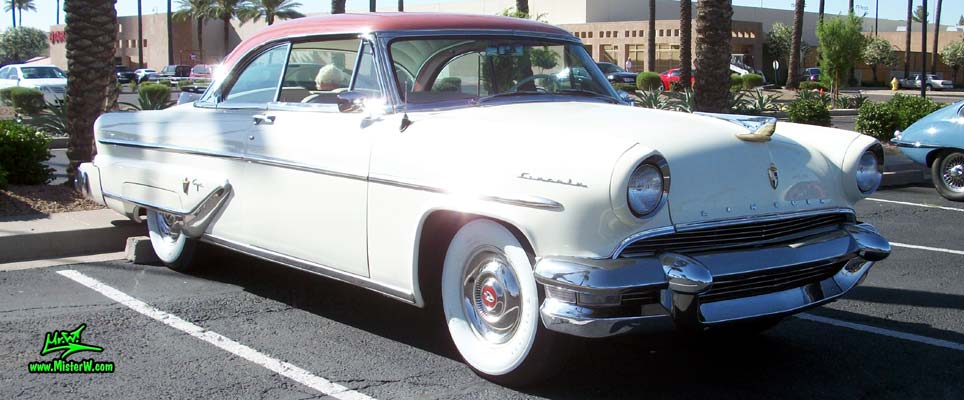 Photo of a white 1955 Lincoln Capri 2 door hardtop coupe at the Scottsdale Pavilions Classic Car Show in Arizona. Chrome trim of a 1955 Lincoln Capri hardtop coupe