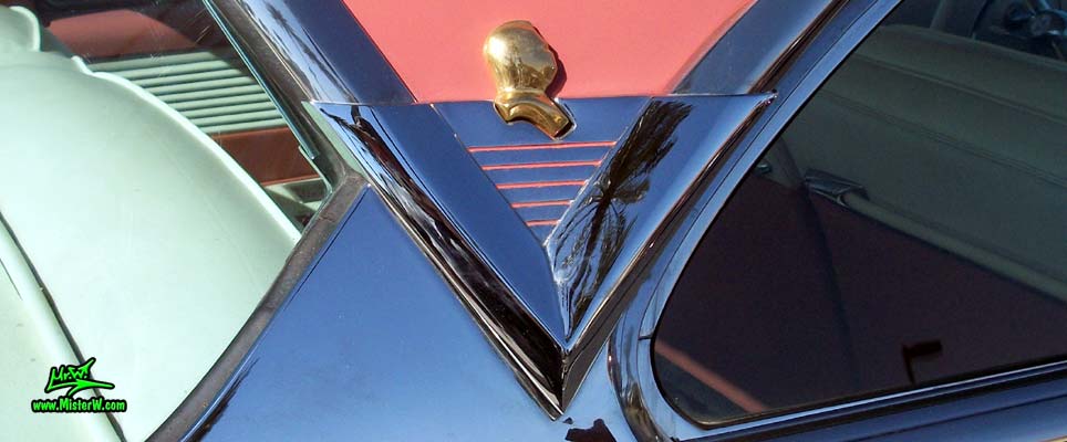 Photo of a white 1955 Lincoln Capri 2 door hardtop coupe at the Scottsdale Pavilions Classic Car Show in Arizona. Chrome trim & gold ornament of a 1955 Lincoln Capri hardtop coupe