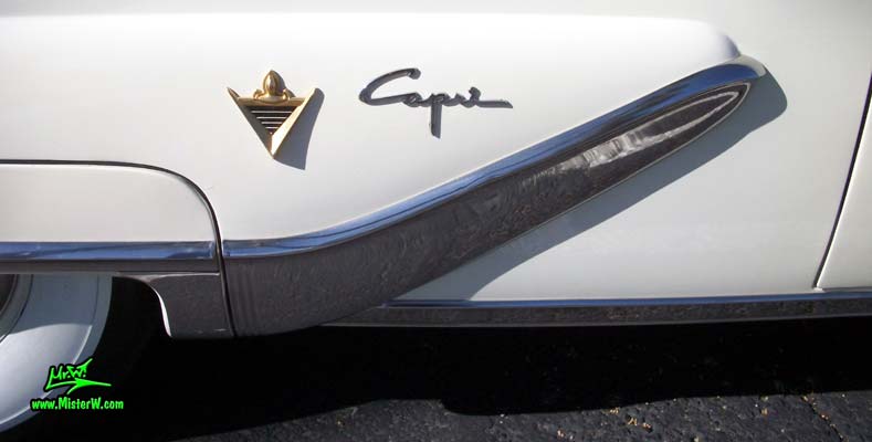Photo of a white 1955 Lincoln Capri 2 door hardtop coupe at the Scottsdale Pavilions Classic Car Show in Arizona. Chrome trim & fender skirt of a 1955 Lincoln Capri hardtop coupe