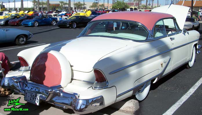 Photo of a white 1955 Lincoln Capri 2 door hardtop coupe at the Scottsdale Pavilions Classic Car Show in Arizona. Tail fins of a 1955 Lincoln Capri