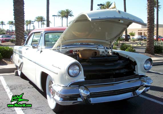 Photo of a white 1955 Lincoln Capri 2 door hardtop coupe at the Scottsdale Pavilions Classic Car Show in Arizona. 1955 Lincoln Capri hardtop coupe with open hood