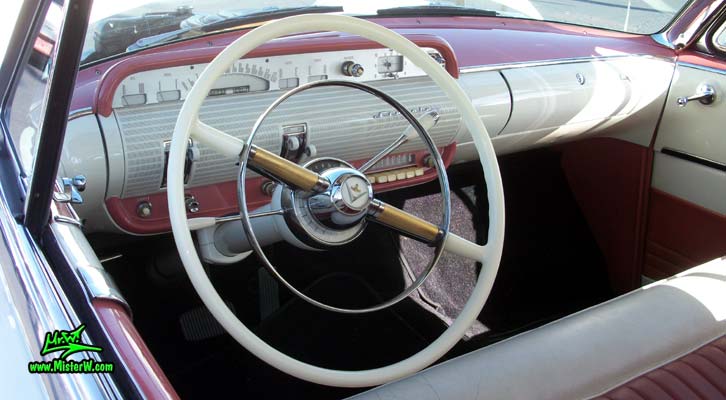Photo of a white 1955 Lincoln Capri 2 door hardtop coupe at the Scottsdale Pavilions Classic Car Show in Arizona. Dash board & speedometer of a 1955 Lincoln Capri hardtop coupe