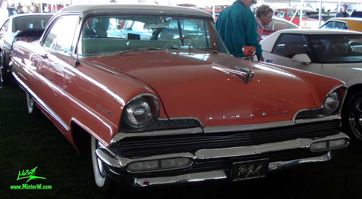 Photo of a pink 1956 Lincoln Premiere 2 door hardtop coupe at a Classic Car Auction in Scottsdale, Arizona. Frontview of a 1956 Lincoln Premiere
