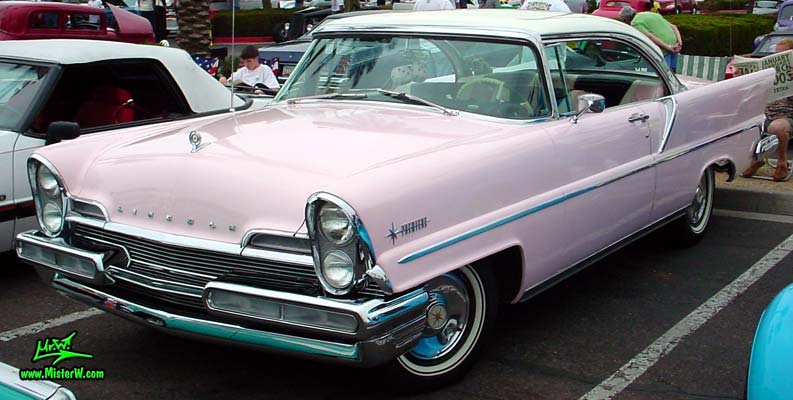 Photo of a pink & white 1957 Lincoln Premiere 2 door hardtop coupe at the Scottsdale Pavilions Classic Car Show in Arizona. 57 Lincoln Coupe