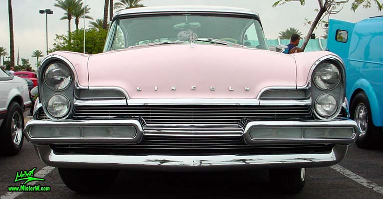 Photo of a pink & white 1957 Lincoln Premiere 2 door hardtop coupe at the Scottsdale Pavilions Classic Car Show in Arizona. Front view of a 1957 Lincoln Premiere hardtop coupe