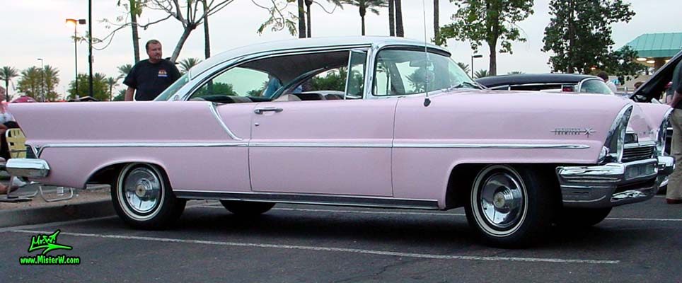 Photo of a pink & white 1957 Lincoln Premiere 2 door hardtop coupe at the Scottsdale Pavilions Classic Car Show in Arizona. Side view of a 1957 Lincoln Premiere hardtop coupe