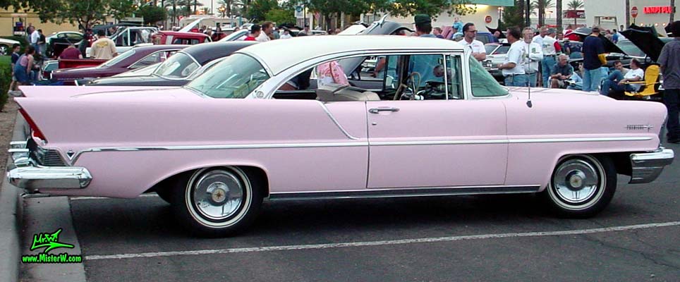 Photo of a pink & white 1957 Lincoln Premiere 2 door hardtop coupe at the Scottsdale Pavilions Classic Car Show in Arizona. Side lines of a 1957 Lincoln Premiere hardtop coupe