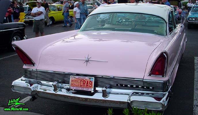 Photo of a pink & white 1957 Lincoln Premiere 2 door hardtop coupe at the Scottsdale Pavilions Classic Car Show in Arizona. Tail lights of a 1957 Lincoln Premiere hardtop coupe