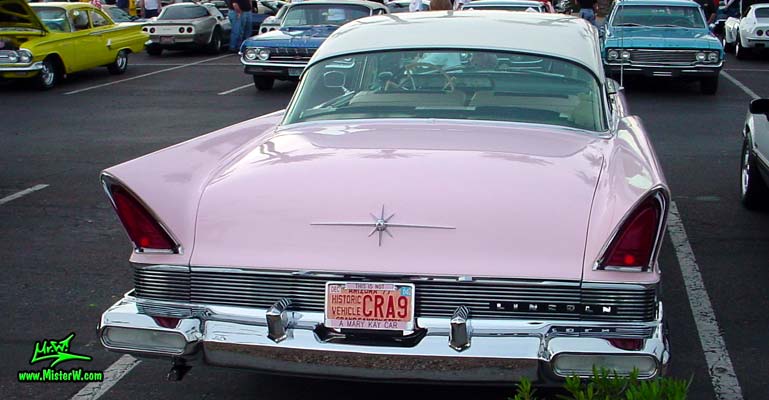 Photo of a pink & white 1957 Lincoln Premiere 2 door hardtop coupe at the Scottsdale Pavilions Classic Car Show in Arizona. Rear view of a 1957 Lincoln Premiere hardtop coupe