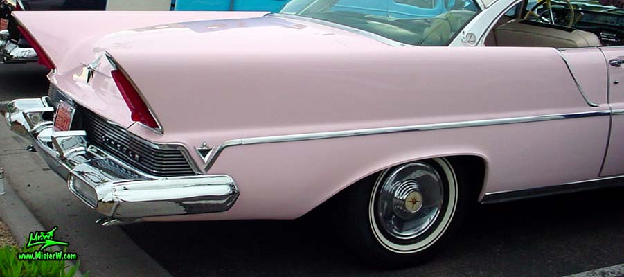 Photo of a pink & white 1957 Lincoln Premiere 2 door hardtop coupe at the Scottsdale Pavilions Classic Car Show in Arizona. Tailfin of a 1957 Lincoln Premiere hardtop coupe