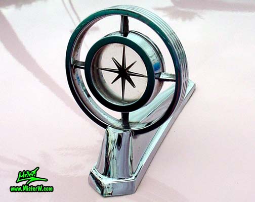 Photo of a pink & white 1957 Lincoln Premiere 2 door hardtop coupe at the Scottsdale Pavilions Classic Car Show in Arizona. Hood ornament of a 1957 Lincoln Premiere hardtop coupe