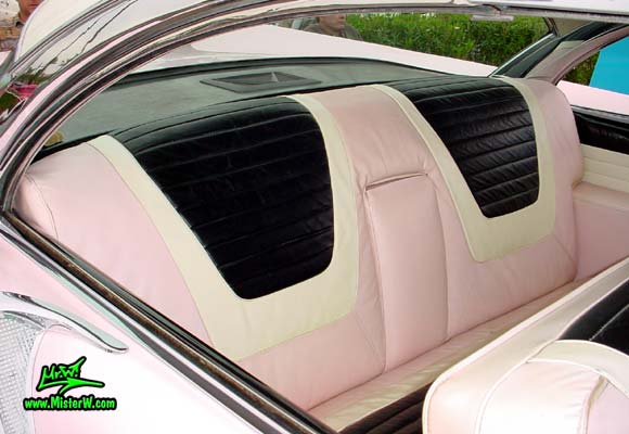 Photo of a pink & white 1957 Lincoln Premiere 2 door hardtop coupe at the Scottsdale Pavilions Classic Car Show in Arizona. Interior & rear seat bench of a 1957 Lincoln Premiere hardtop coupe