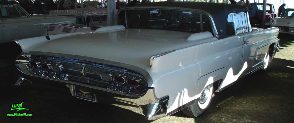 Photo of a white 1959 Lincoln Continental Mark IV convertible at a Classic Car Auction in Scottsdale, Arizona. Side view of a 1959 Lincoln Continental Mark IV Convertible