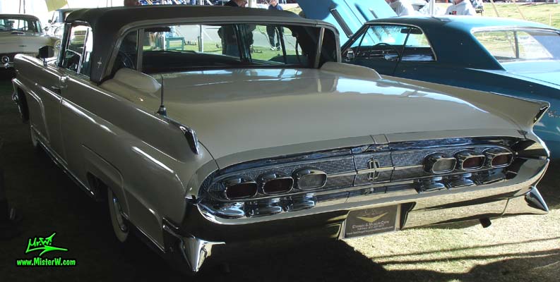 Photo of a white 1959 Lincoln Continental Mark IV convertible at a Classic Car Auction in Scottsdale, Arizona. Rear view of a 1959 Lincoln Continental Mark IV Convertible