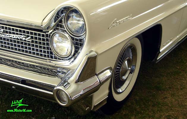 Photo of a white 1959 Lincoln Continental Mark IV convertible at a Classic Car Auction in Scottsdale, Arizona. Headlights of a 1959 Lincoln Continental Mark IV Convertible