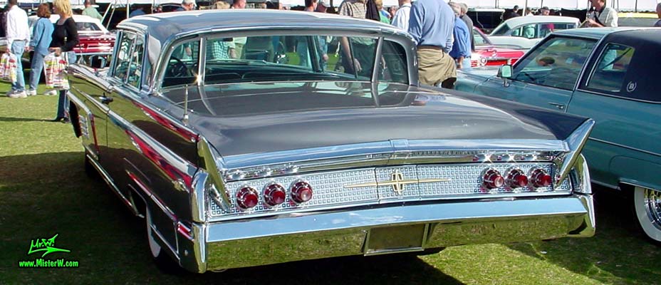 Photo of a silver gray metallic 1960 Lincoln Continental Mark V 2 door hardtop coupe at a Classic Car Auction in Scottsdale, Arizona. Rear chrome trim & tailfins of a 1960 Lincoln Continental Mark V coupe