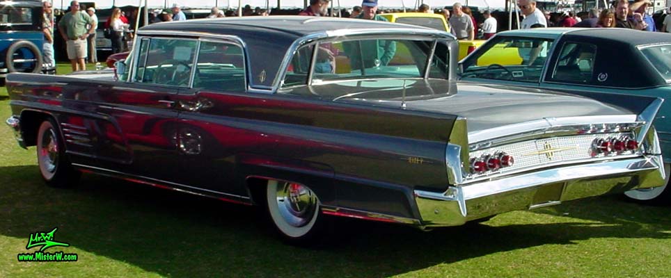 Photo of a silver gray metallic 1960 Lincoln Continental Mark V 2 door hardtop coupe at a Classic Car Auction in Scottsdale, Arizona. Side view of a 1960 Lincoln Continental Mark V coupe