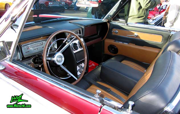 Photo of a red & white 1961 Lincoln Continental 4 door convertible at the Scottsdale Pavilions Classic Car Show in Arizona. Front seat bench of a 1961 Lincoln Continental convertible