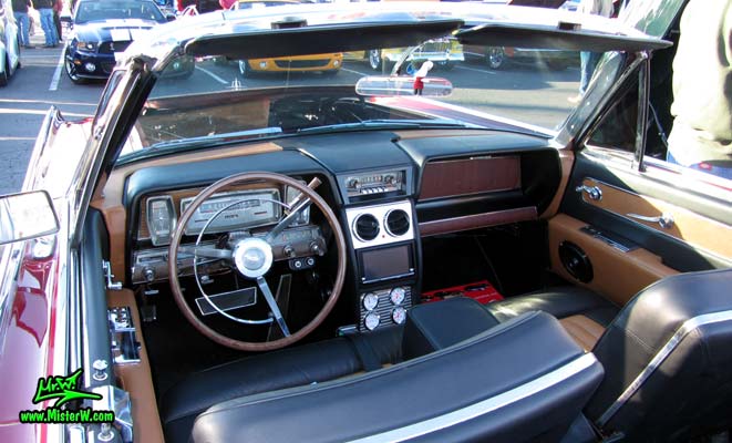 Photo of a red & white 1961 Lincoln Continental 4 door convertible at the Scottsdale Pavilions Classic Car Show in Arizona. Dash board of a 1961 Lincoln Continental convertible