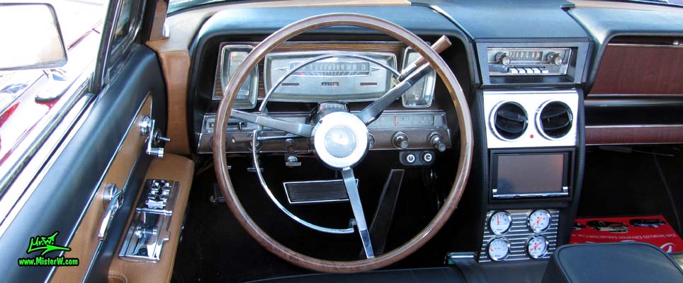 Photo of a red & white 1961 Lincoln Continental 4 door convertible at the Scottsdale Pavilions Classic Car Show in Arizona. Speedometer of a 1961 Lincoln Continental convertible