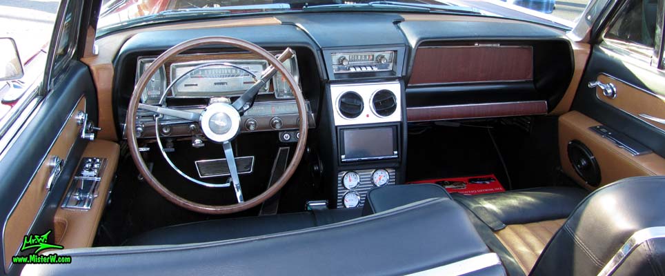 Photo of a red & white 1961 Lincoln Continental 4 door convertible at the Scottsdale Pavilions Classic Car Show in Arizona. Dash board & speedometer of a 1961 Lincoln Continental