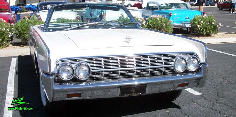 Photo of a white 1962 Lincoln Continental 4 door convertible at the Scottsdale Pavilions Classic Car Show in Arizona. Front view of a 1962 Lincoln Continental convertible