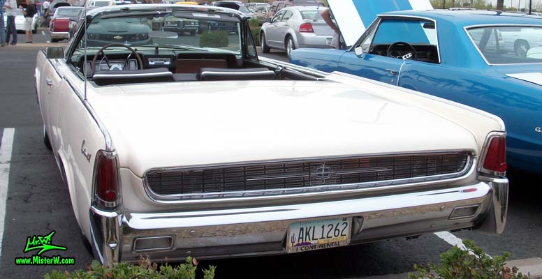 Photo of a white 1962 Lincoln Continental 4 door convertible at the Scottsdale Pavilions Classic Car Show in Arizona. Back of a 1962 Lincoln Continental convertible