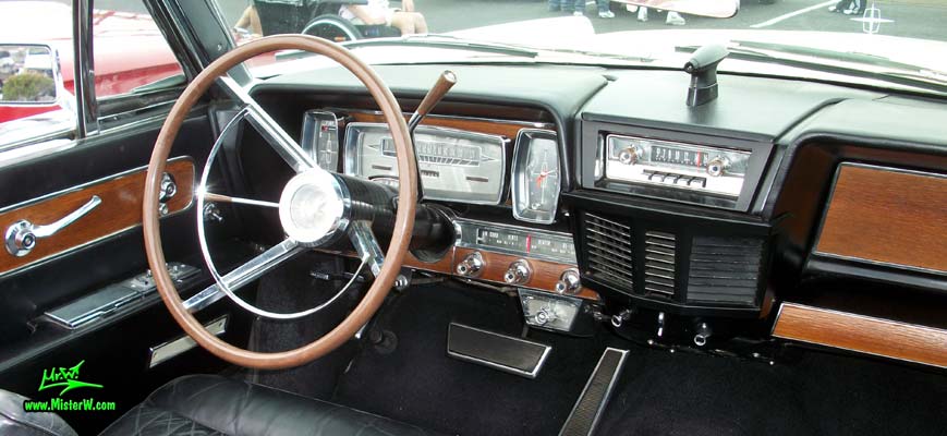 Photo of a white 1962 Lincoln Continental 4 door convertible at the Scottsdale Pavilions Classic Car Show in Arizona. Speedometer & odometer of a 1962 Lincoln Continental convertible