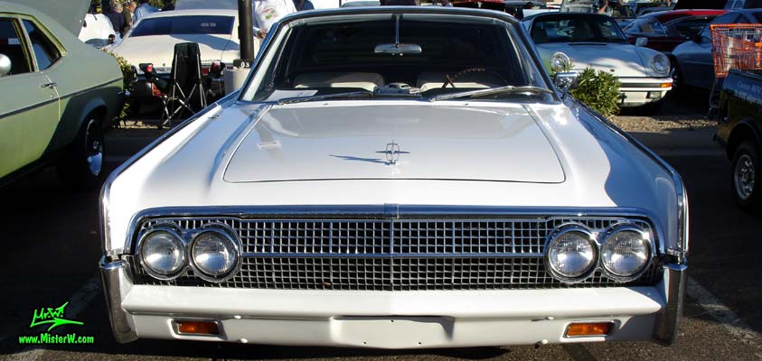 Photo of a white 1963 Lincoln Continental 4 door hardtop sedan at the Scottsdale Pavilions Classic Car Show in Arizona. Front view of a 1963 Lincoln Continental