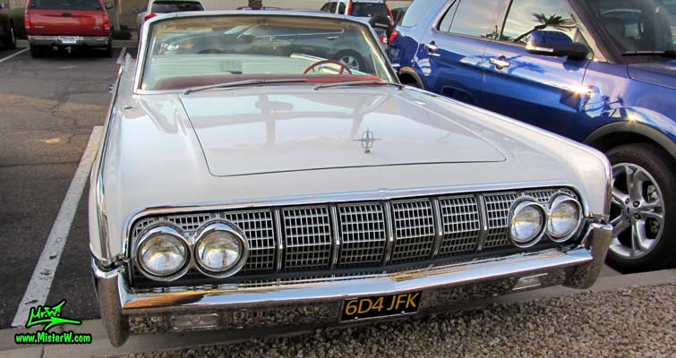 Photo of a white 1964 Lincoln Continental 4 door convertible at the Scottsdale Pavilions Classic Car Show in Arizona. Front chrome grill of a 1964 Lincoln Continental convertible