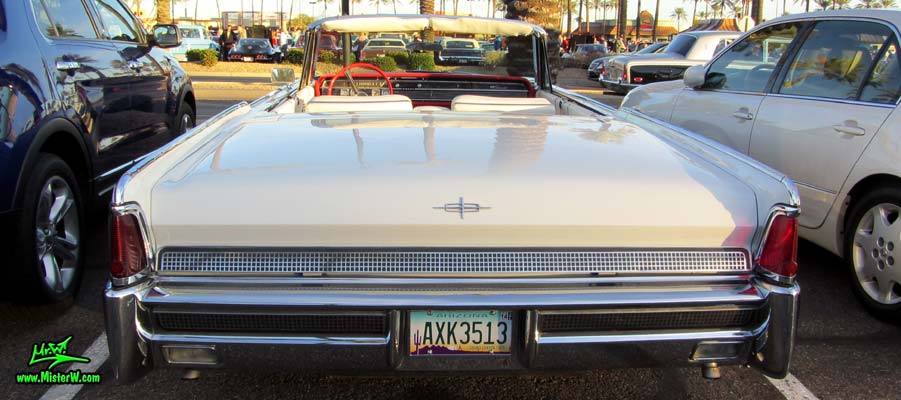 Photo of a white 1964 Lincoln Continental 4 door convertible at the Scottsdale Pavilions Classic Car Show in Arizona. Rear view of a 1964 Lincoln Continental convertible