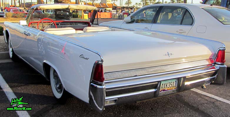 Photo of a white 1964 Lincoln Continental 4 door convertible at the Scottsdale Pavilions Classic Car Show in Arizona. Tail lights & fins of a 1964 Lincoln Continental convertible