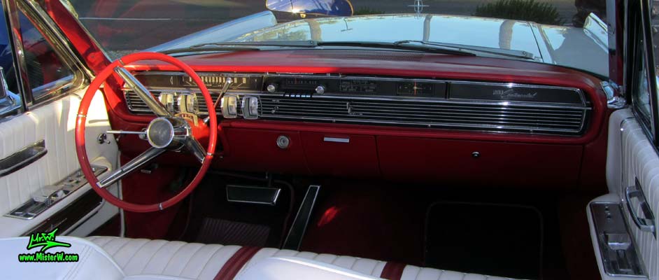 Photo of a white 1964 Lincoln Continental 4 door convertible at the Scottsdale Pavilions Classic Car Show in Arizona. Dashboard & gauges of a 1964 Lincoln Continental convertible
