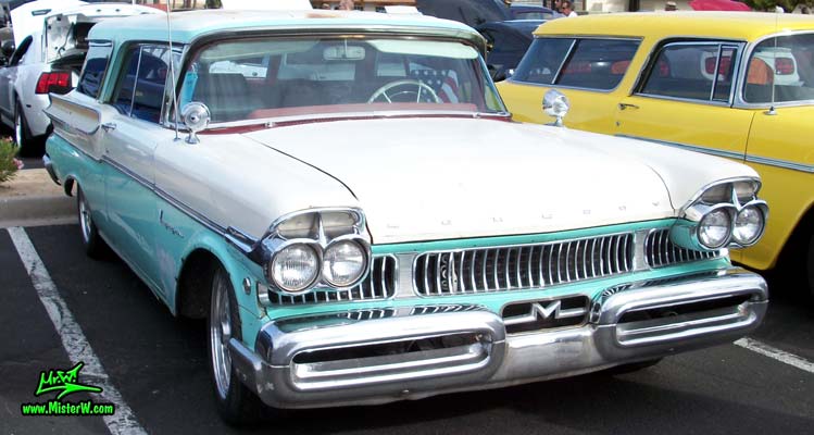 Photo of a white & turkquoise 1957 Mercury Voyager 2 Door Station Wagon at the Scottsdale Pavilions Classic Car Show in Arizona. 57 Mercury Station Wagon Chrome Grill & Bumper