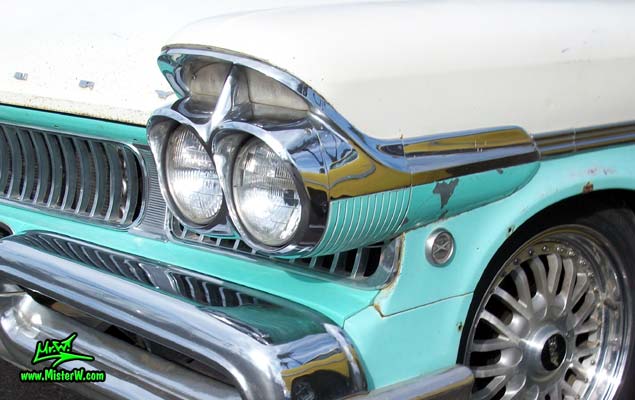 Photo of a white & turkquoise 1957 Mercury Voyager 2 Door Station Wagon at the Scottsdale Pavilions Classic Car Show in Arizona. Headlight of a 1957 Mercury Voyager 2 Door Station Wagon