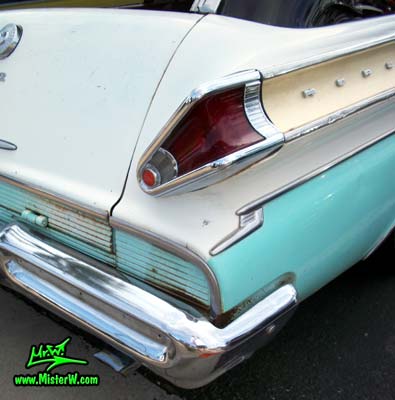 Photo of a white & turkquoise 1957 Mercury Voyager 2 Door Station Wagon at the Scottsdale Pavilions Classic Car Show in Arizona. Taillight of a 1957 Mercury Voyager 2 Door Station Wagon