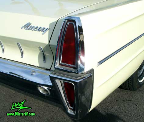 Photo of a tan & white 1965 Mercury 4 door sedan at the Scottsdale Pavilions Classic Car Show in Arizona. Tail lights & rear bumper of a 1965 Mercury