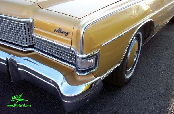 Photo of a gold brown 1973 Mercury 2 door hartop coupe at the Scottsdale Pavilions Classic Car Show in Arizona. Front blinker & chrome of a 1973 Mercury Hartop Coupe