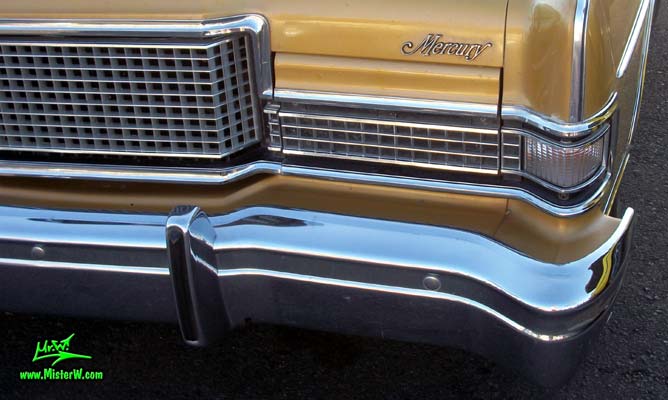 Photo of a gold brown 1973 Mercury 2 door hartop coupe at the Scottsdale Pavilions Classic Car Show in Arizona. Hidden head light of a 1973 Mercury Hartop Coupe