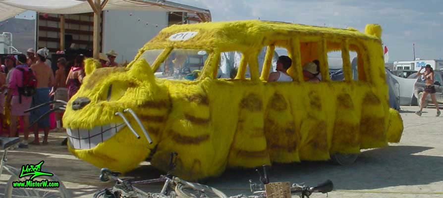 Photo of the furry yellow Cat Bus Mutant Vehicle / Art Car in Black Rock City, Nevada, 2002. Cat Bus Art Car